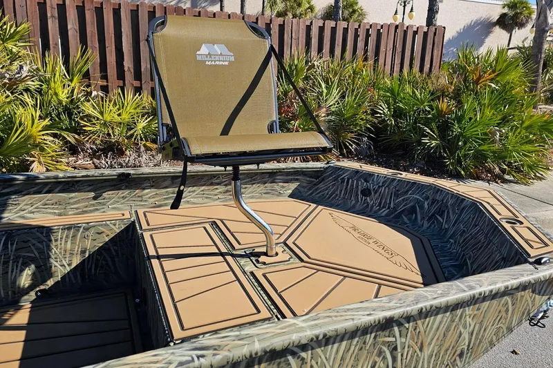 Slide: The Image of 2026 Tracker Grizzly 1650 T Prairie Wings Edition boat with camo design and swivel seat. - 4