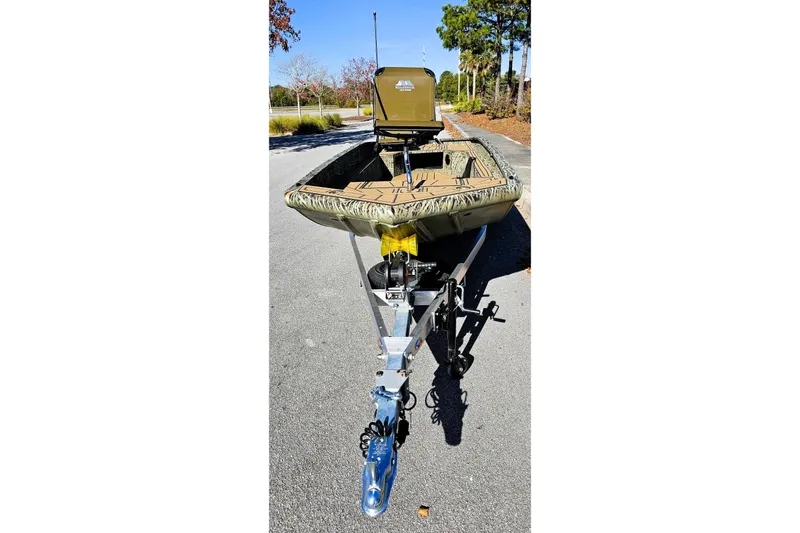 Slide: The Image of 2026 Tracker Grizzly 1650 T Prairie Wings Edition boat on trailer, outdoor setting. - 8