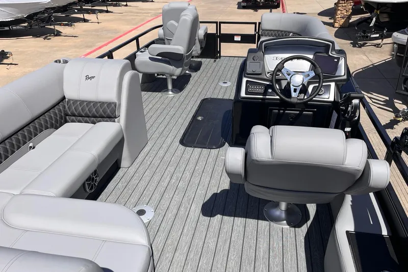 Slide: The Image of 2026 Ranger 223FC boat interior with gray seating and modern steering console. - 3
