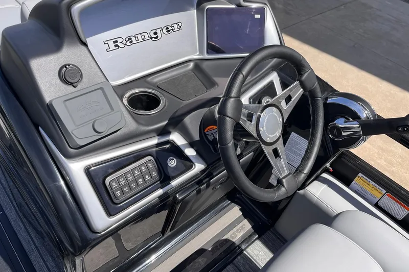 Slide: The Image of 2026 Ranger 223FC boat dashboard with steering wheel and control panel. - 4
