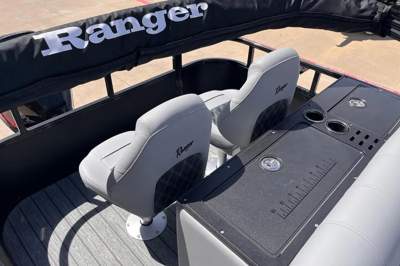 Slide: The Image of 2026 Ranger 223FC boat interior with seating and console, featuring cup holders and storage. - 5
