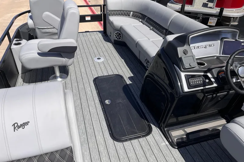 Slide: The Image of 2026 Ranger 223FC boat interior with gray seating and modern dashboard. - 6