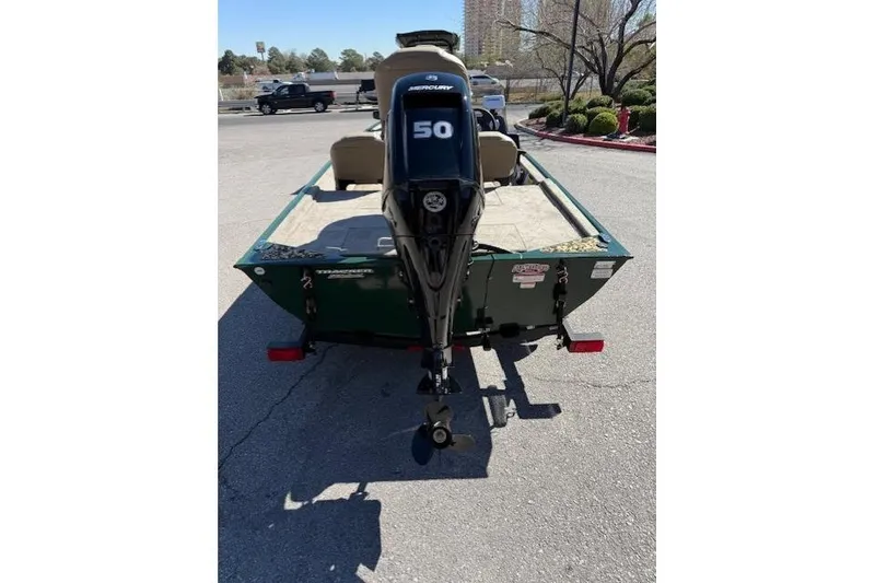 Slide: The Image of 2026 Tracker Bass Tracker Classic Limited boat with Mercury 50 engine, parked outdoors. - 3