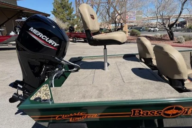 Slide: The Image of 2026 Tracker Bass Tracker Classic Limited boat with Mercury engine and beige seats. - 4