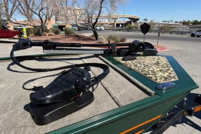 Slide: The Image of 2026 Tracker Bass Tracker Classic Limited boat with trolling motor in a parking lot. - 5