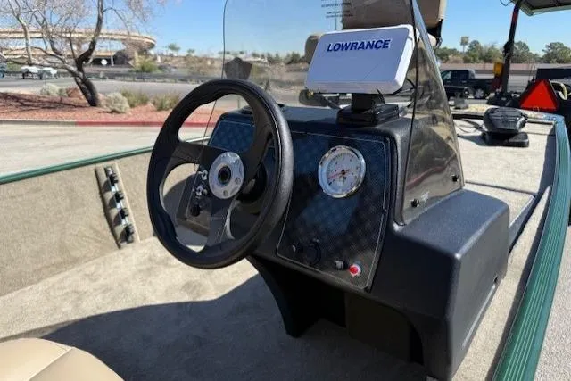 Slide: The Image of 2026 Tracker Bass Tracker Classic Limited boat dashboard with steering wheel and Lowrance navigation system. - 6