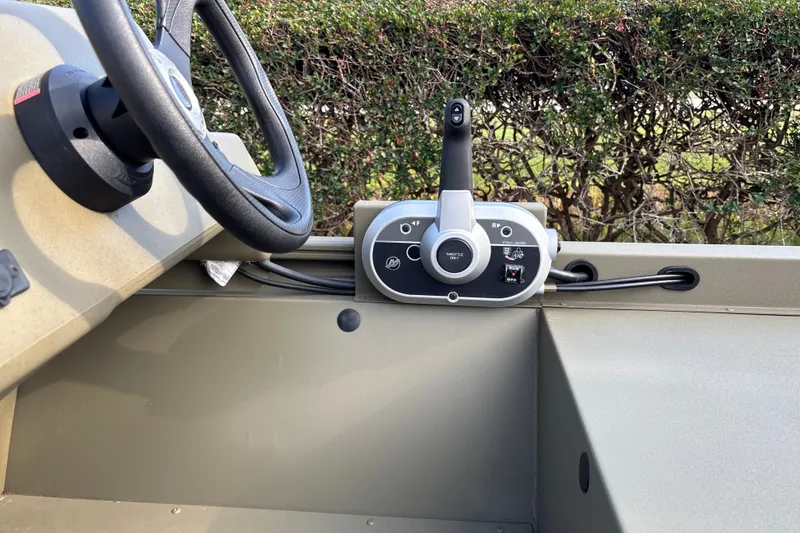 Slide: The Image of 2026 Tracker Grizzly 1648 SC boat steering wheel and throttle control panel. - 19