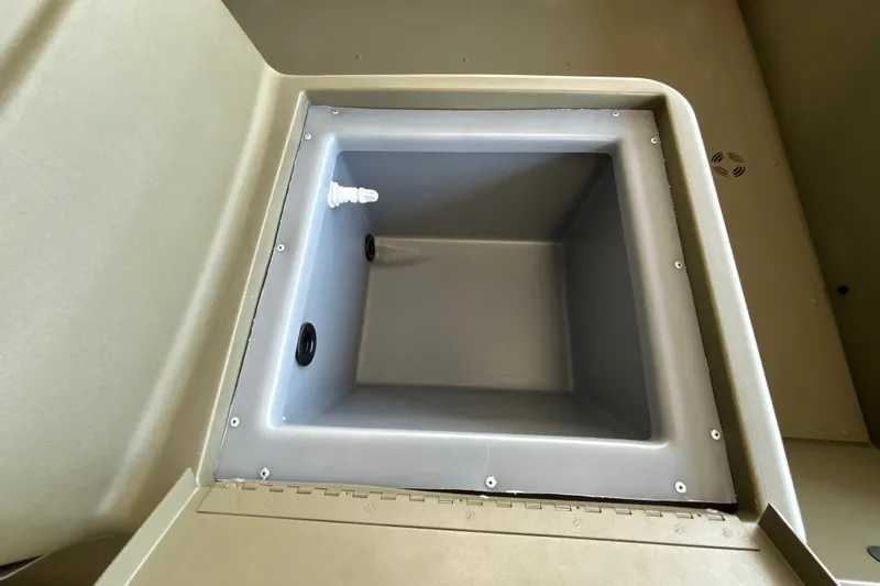 Slide: The Image of 2026 Tracker Grizzly 1648 SC boat storage compartment, open and empty. - 21