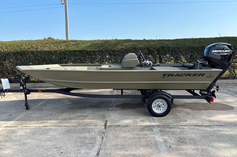 The Image of 2026 Tracker Grizzly 1648 SC boat on trailer, featuring Mercury outboard motor. - 0