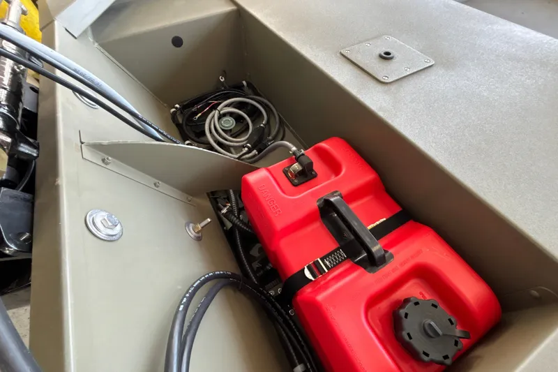 Slide: The Image of 2026 Tracker Grizzly 1648 SC boat interior with red fuel tank and wiring. - 22