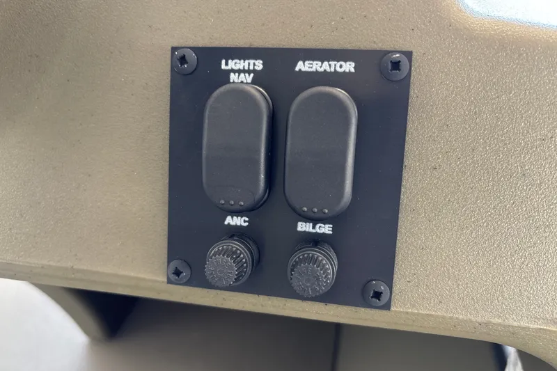 Slide: The Image of Control panel of 2026 Tracker Grizzly 1648 SC with switches for lights, aerator, and bilge. - 17