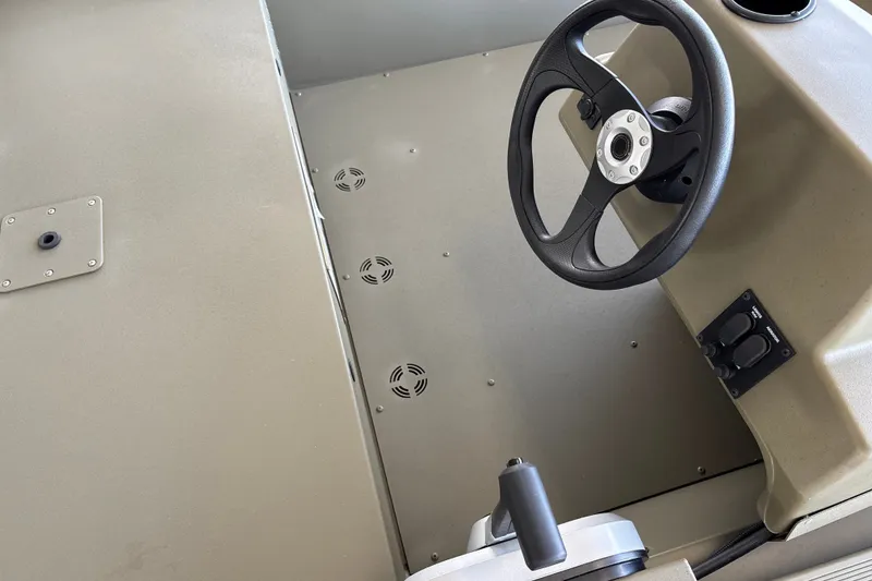 Slide: The Image of Steering console of 2026 Tracker Grizzly 1648 SC boat, featuring a sleek design. - 15