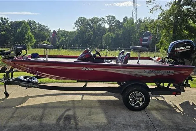 Slide: The Image of 2026 Ranger RT178 fishing boat with Mercury engine on trailer, parked outdoors. - 7