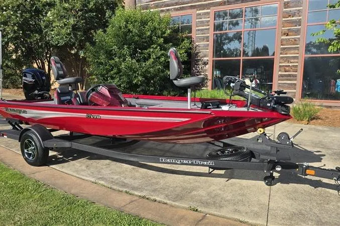 Slide: The Image of 2026 Ranger RT178 boat in vibrant red on a trailer, parked outdoors. - 6