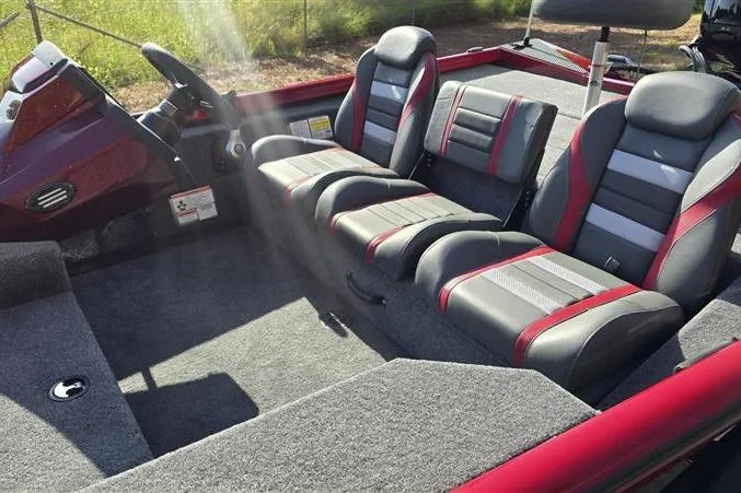 Slide: The Image of 2026 Ranger RT178 boat interior with gray and red seating, steering console, and carpeted flooring. - 9