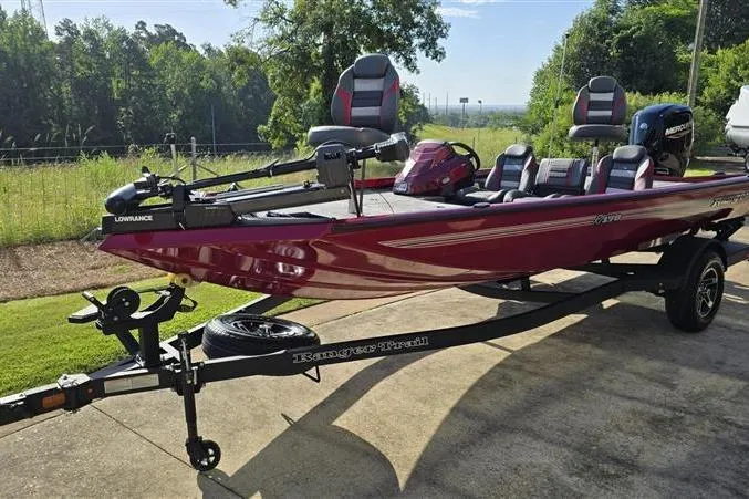 Slide: The Image of 2026 Ranger RT178 boat on trailer, red color, parked outdoors, featuring Lowrance equipment. - 5