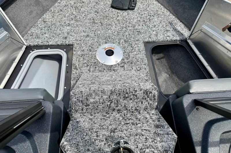 Slide: The Image of Interior view of 2026 Tracker Pro Guide V-175 Combo boat with carpeted flooring and storage compartments. - 13