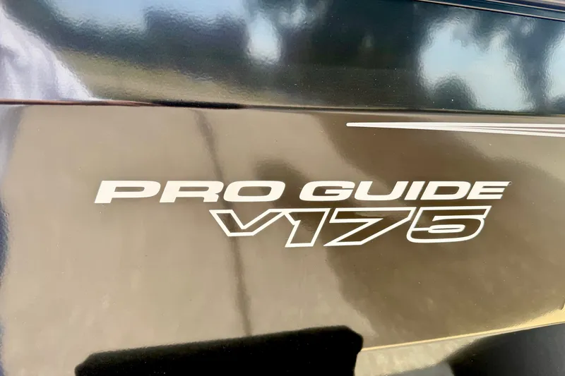 Slide: The Image of 2026 Tracker Pro Guide V-175 Combo boat logo on a sleek black surface. - 18