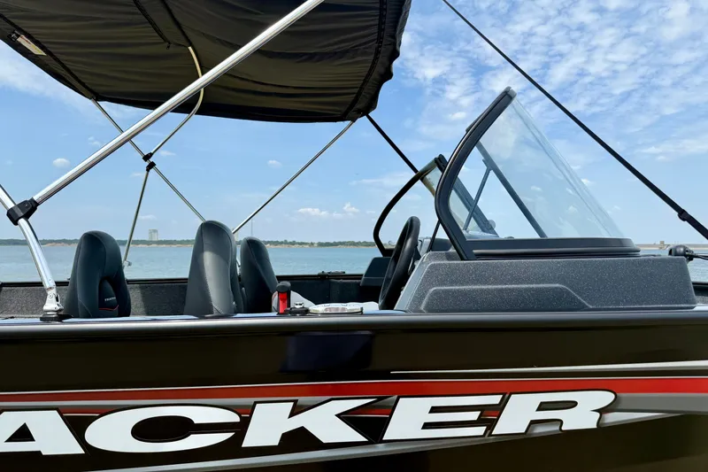 Slide: The Image of 2026 Tracker Pro Guide V-175 Combo boat on a lake under a clear sky. - 4