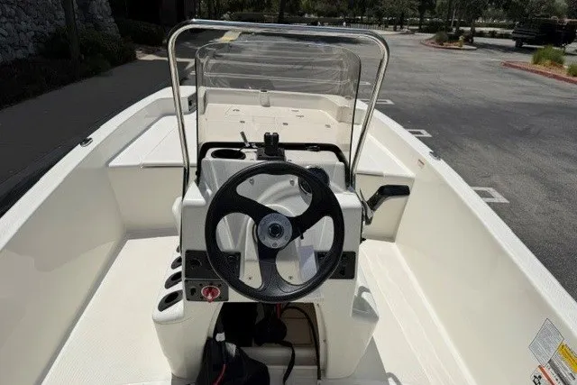 Slide: The Image of 2026 Mako Pro Skiff 17 CC boat interior with steering wheel and console. - 6