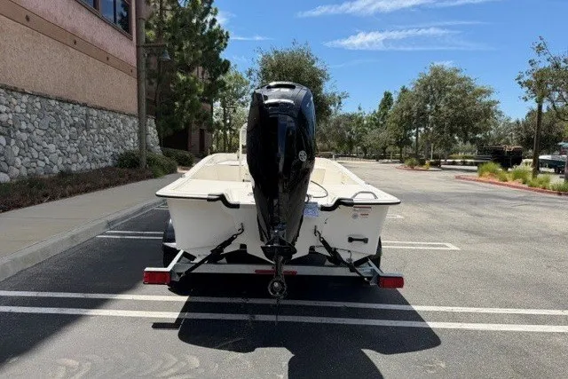 Slide: The Image of 2026 Mako Pro Skiff 17 CC boat on trailer in parking lot, rear view. - 5