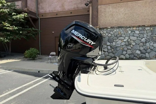 Slide: The Image of 2026 Mako Pro Skiff 17 CC with Mercury outboard motor in parking lot. - 4