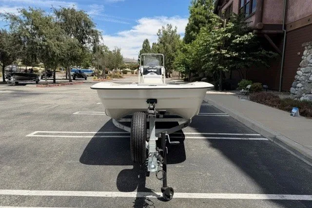 Slide: The Image of 2026 Mako Pro Skiff 17 CC boat on trailer in parking lot. - 2