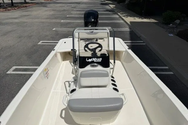 Slide: The Image of 2026 Mako Pro Skiff 17 CC boat in a parking lot, showcasing steering console and seating. - 7