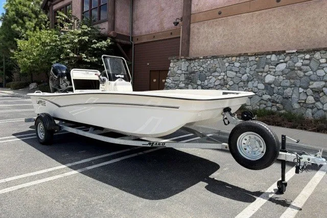 Slide: The Image of 2026 Mako Pro Skiff 17 CC boat on trailer in parking lot. - 3