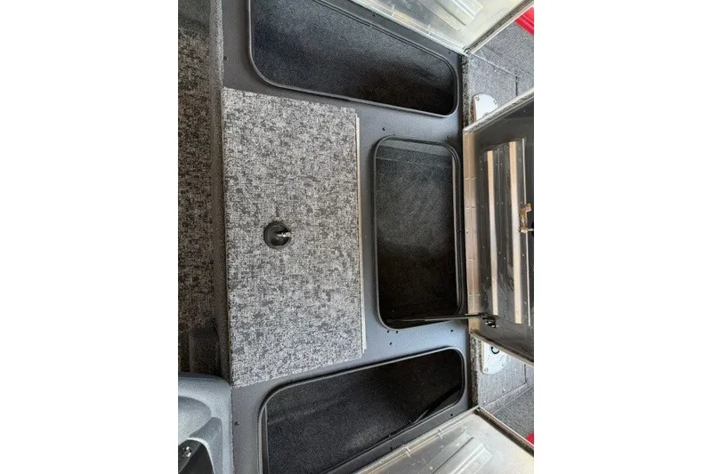 Slide: The Image of 2026 Tracker Pro Team 175 Crappie Edition boat storage compartments, open and empty. - 10
