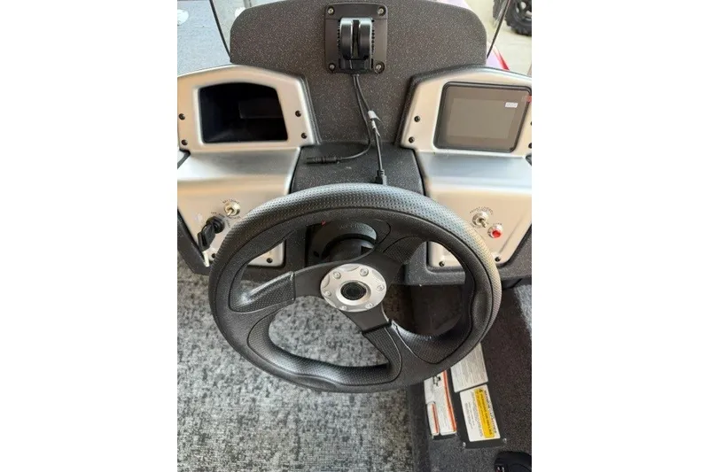 Slide: The Image of Steering console of 2026 Tracker Pro Team 175 Crappie Edition boat, featuring modern controls. - 9