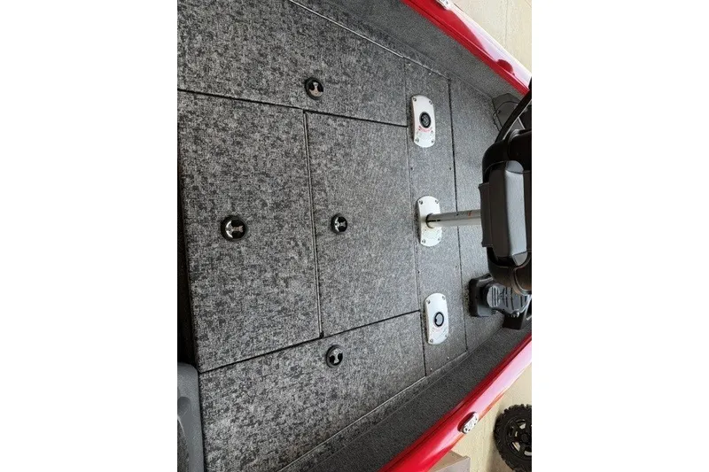Slide: The Image of 2026 Tracker Pro Team 175 Crappie Edition boat interior with gray carpeted deck. - 7
