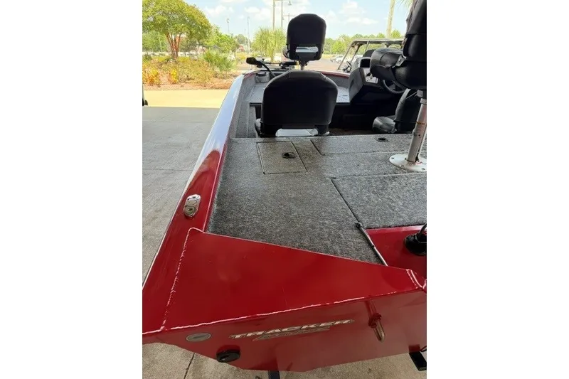 Slide: The Image of 2026 Tracker Pro Team 175 Crappie Edition boat, red exterior, spacious deck, comfortable seating. - 4