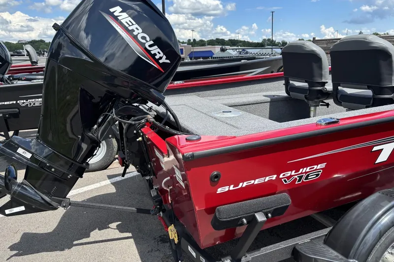 Slide: The Image of 2026 Tracker Super Guide V-16 SC boat with Mercury outboard motor, parked outdoors. - 3