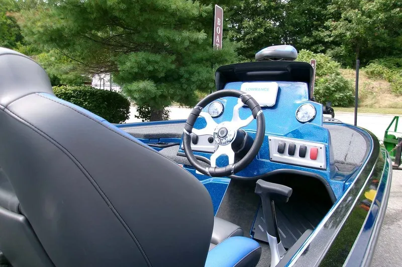 Slide: The Image of Interior view of a 2026 Nitro Z19 XL boat, featuring a sleek steering wheel and control panel. - 7