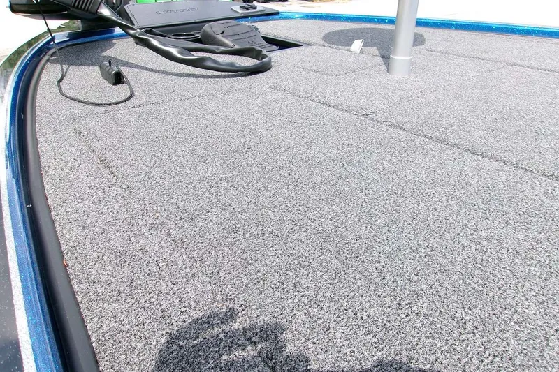 Slide: The Image of 2026 Nitro Z19 XL boat deck with gray carpet and fishing equipment. - 3