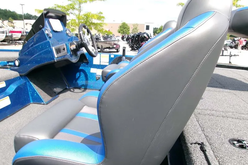 Slide: The Image of 2026 Nitro Z19 XL boat interior with blue and gray seating and steering console. - 8