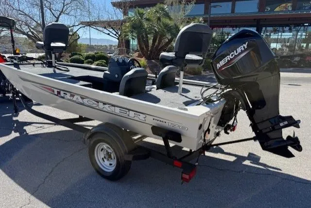 Slide: The Image of 2026 Tracker Pro 170 boat with Mercury engine, parked outdoors on a trailer. - 2