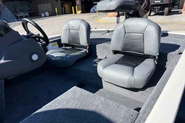 Slide: The Image of 2026 Tracker Pro 170 boat interior with gray seating and steering wheel. - 6