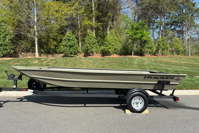 The Image of 2026 Tracker Grizzly 1754 Utility boat on trailer, parked outdoors. - 0
