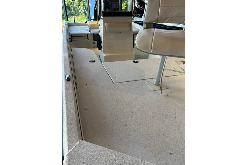 Slide: The Image of 2026 Ranger RB190 boat interior with beige seating and steering console. - 2