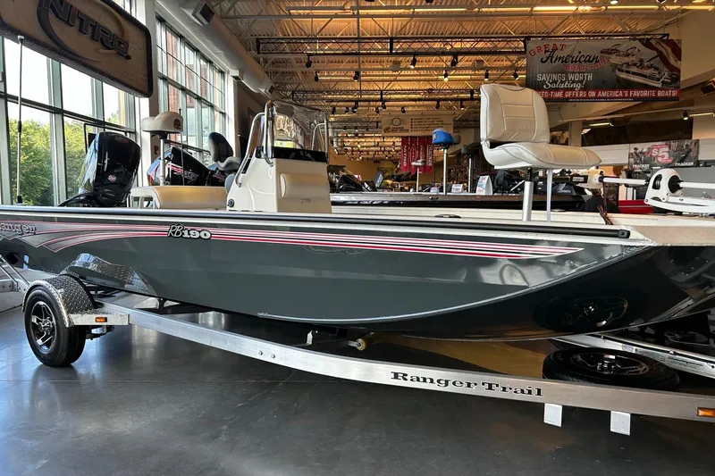 The Image of 2026 Ranger RB190 boat displayed indoors on a trailer, showcasing sleek design and seating. - 0