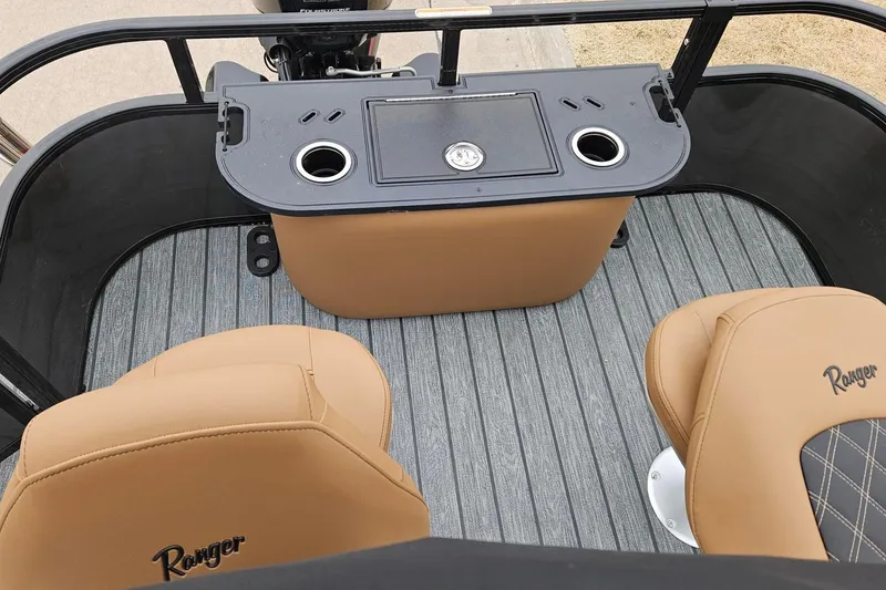Slide: The Image of 2026 Ranger 220F boat interior with tan seats and a central console. - 84