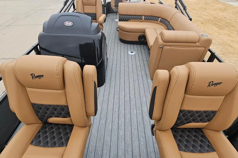 Slide: The Image of 2026 Ranger 220F boat interior with tan and black diamond-stitched seating, showcasing luxury design. - 86