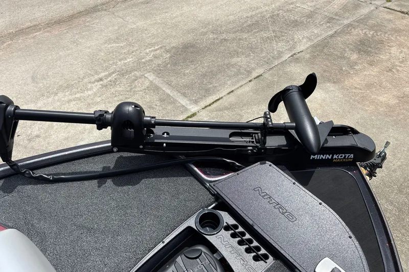 Slide: The Image of 2026 Nitro Z18 boat with Minn Kota Maxxum trolling motor on concrete surface. - 8