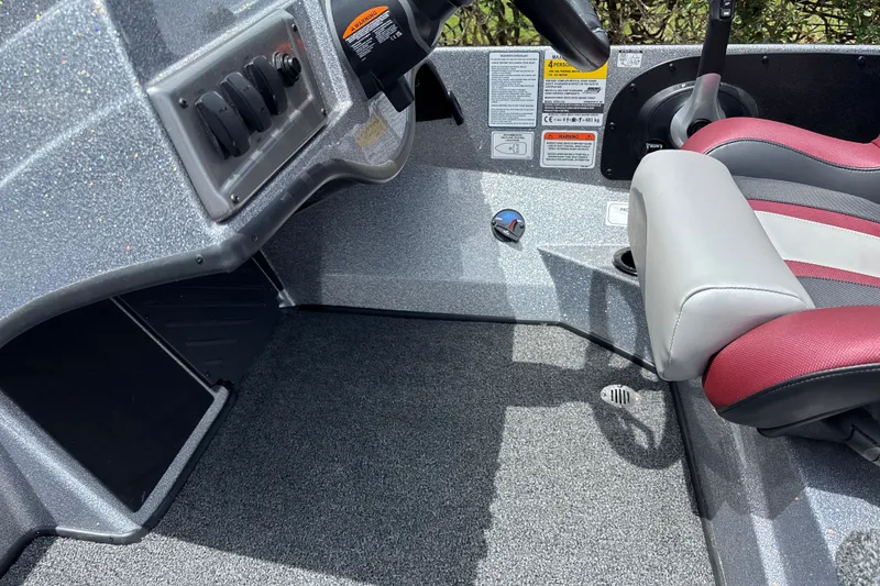 Slide: The Image of Interior of a 2026 Nitro Z18 boat featuring a sleek dashboard and comfortable seating. - 18