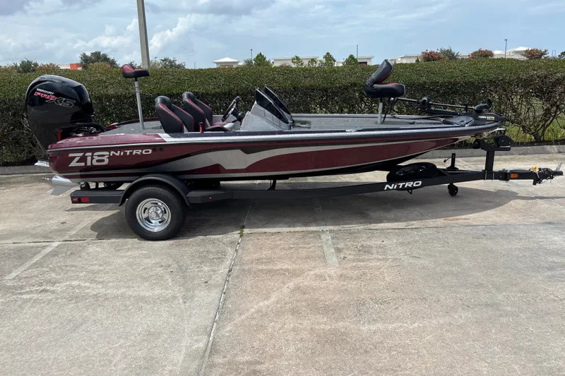 Slide: The Image of 2026 Nitro Z18 boat on trailer, parked outdoors, featuring sleek design and powerful engine. - 3