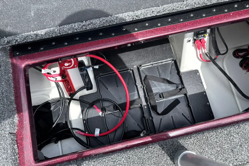 Slide: The Image of Battery compartment of a 2026 Nitro Z18 boat, featuring cables and secure battery mounts. - 29