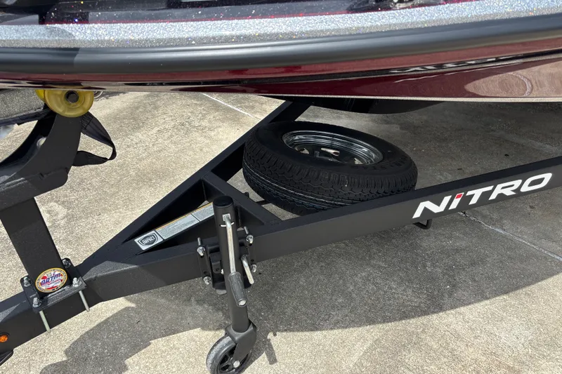 Slide: The Image of Trailer of a 2026 Nitro Z18 boat with spare tire on concrete surface. - 30