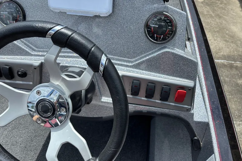 Slide: The Image of Steering wheel and dashboard of a 2026 Nitro Z18 boat, featuring gauges and controls. - 14